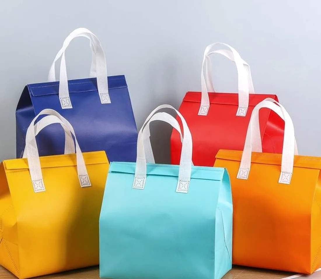 Collection of colorful insulated bags with white handles